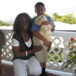 Anita gives a gift to a child