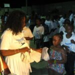 anita_giving_goodies_bags_to_children